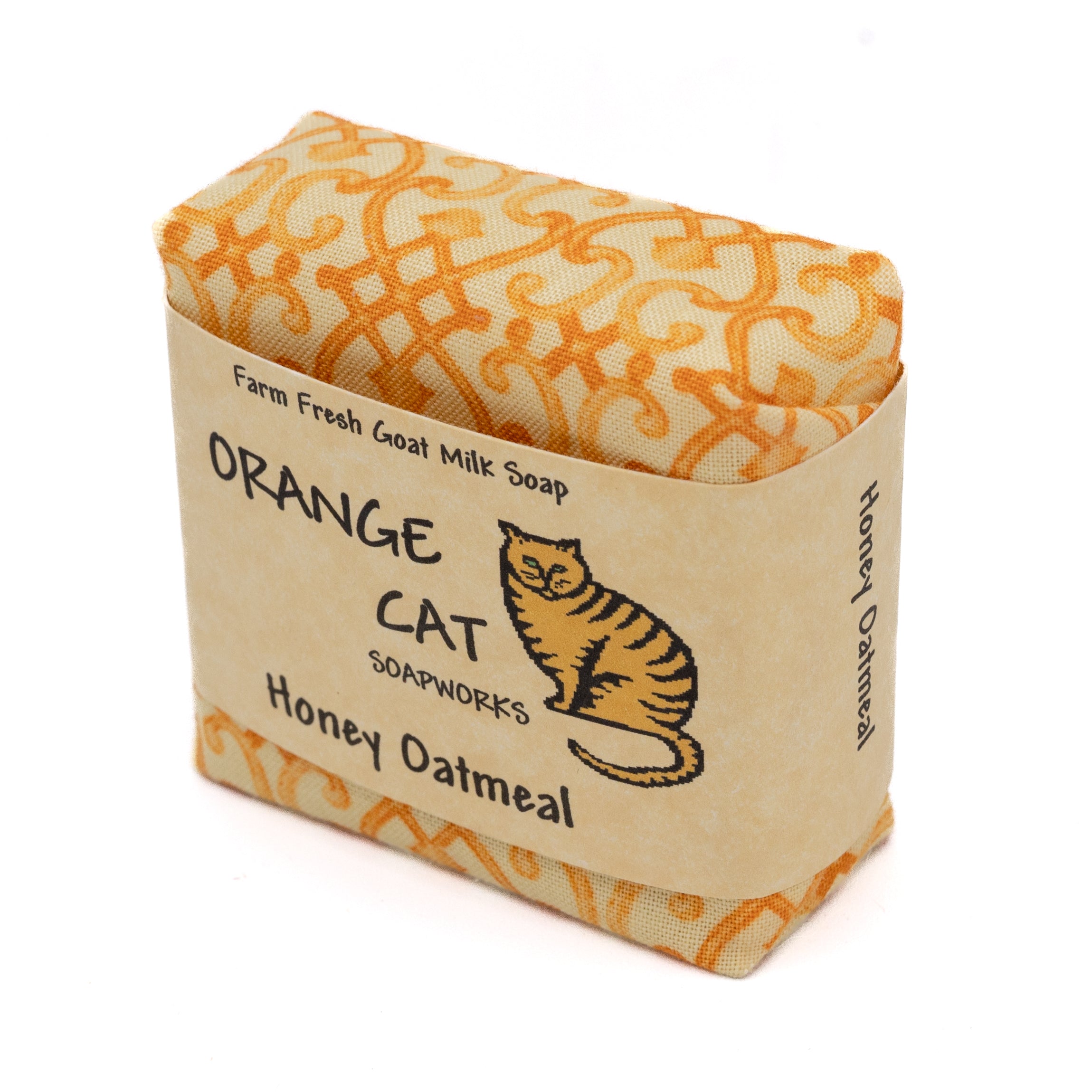 bar of orange cat honey oatmeal soap wrapped in orange fabric with paper label with orange cat drawing